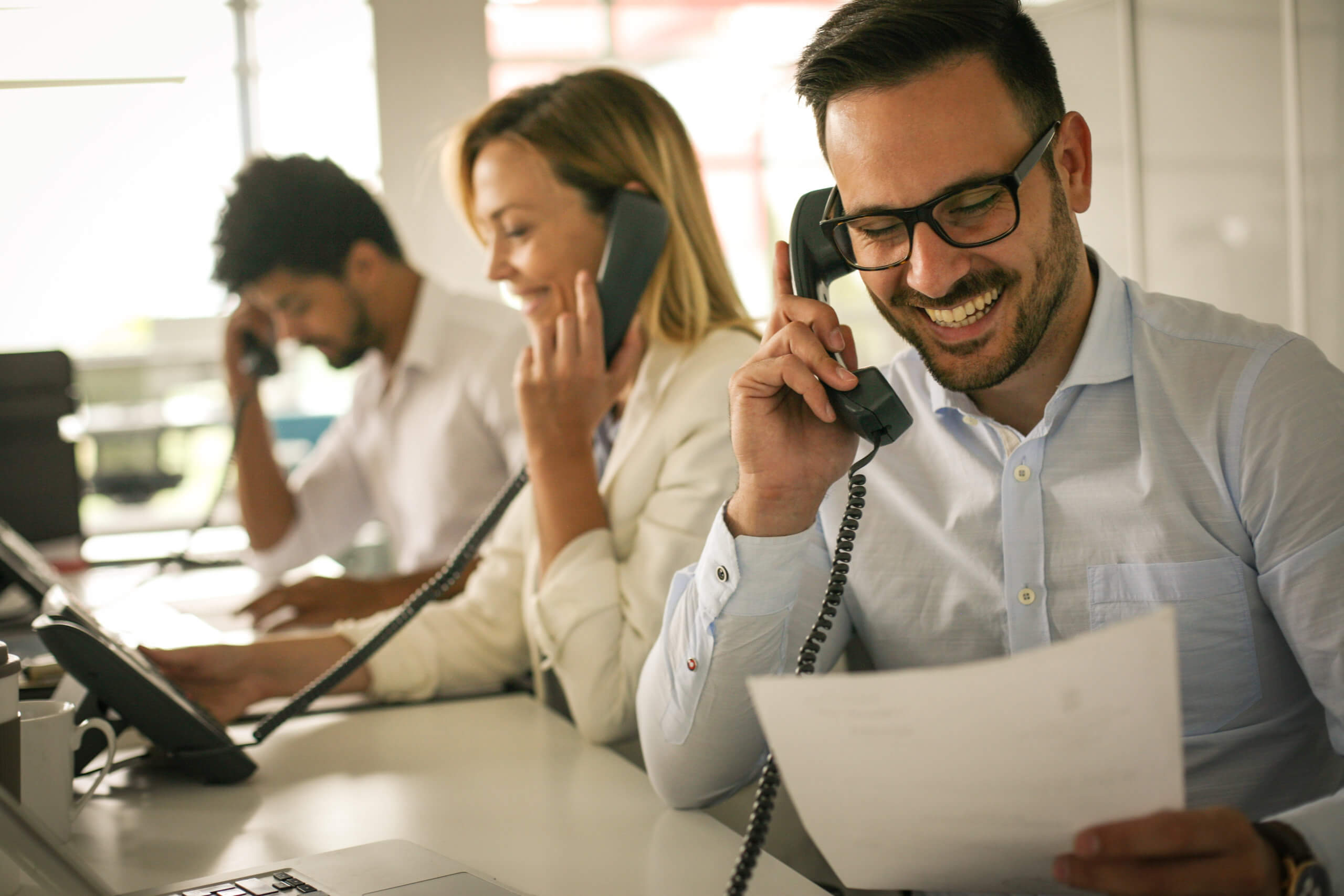 People in operations center talking on Landline phone. Operators in the office.